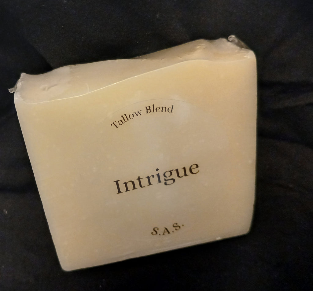 Intrigue tallow blend soap bar with S.A.S. label in cream and gold tones