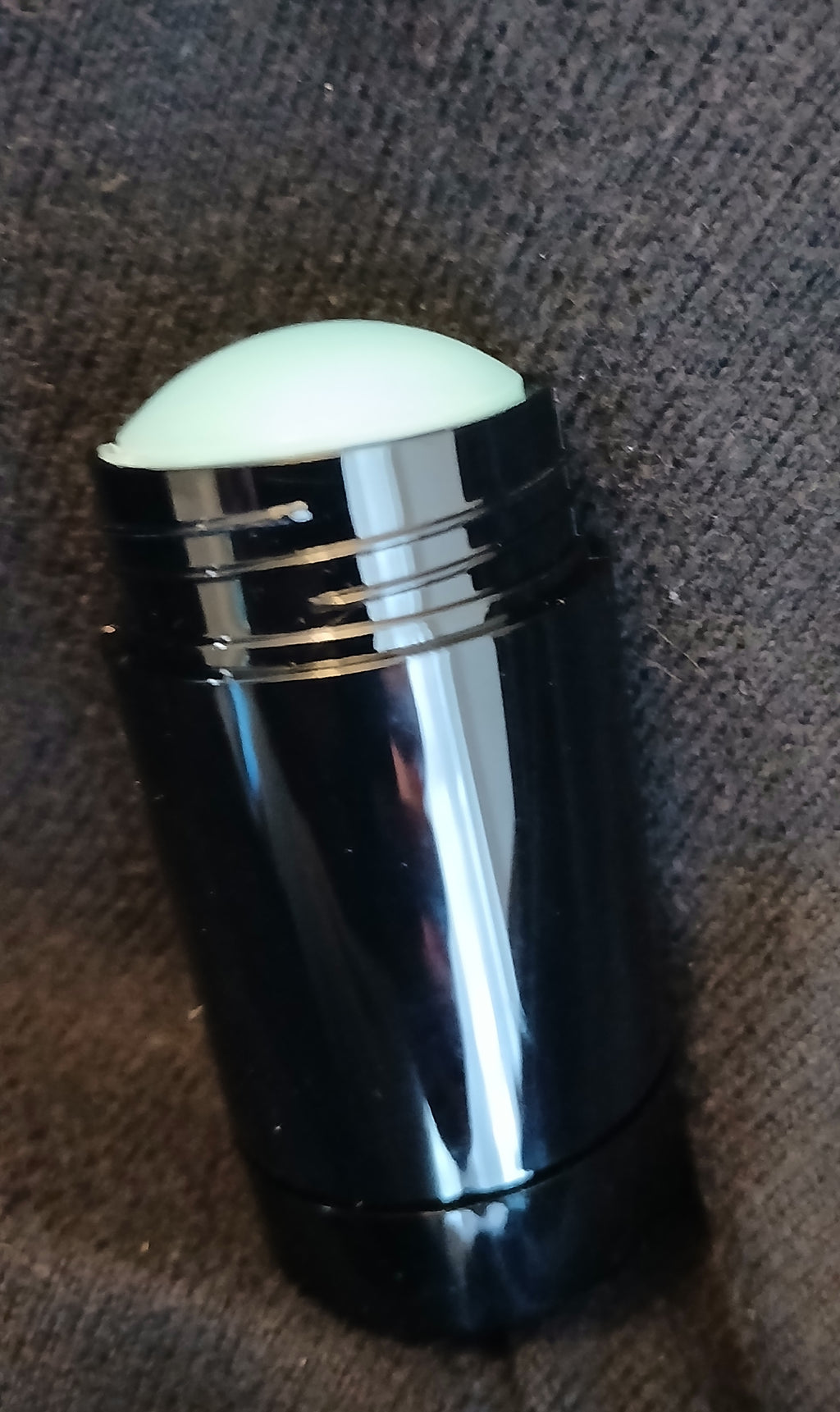 Intrigue Solid Cologne in a sleek black twist-up stick with Blue Amber and Bergamot fragrance