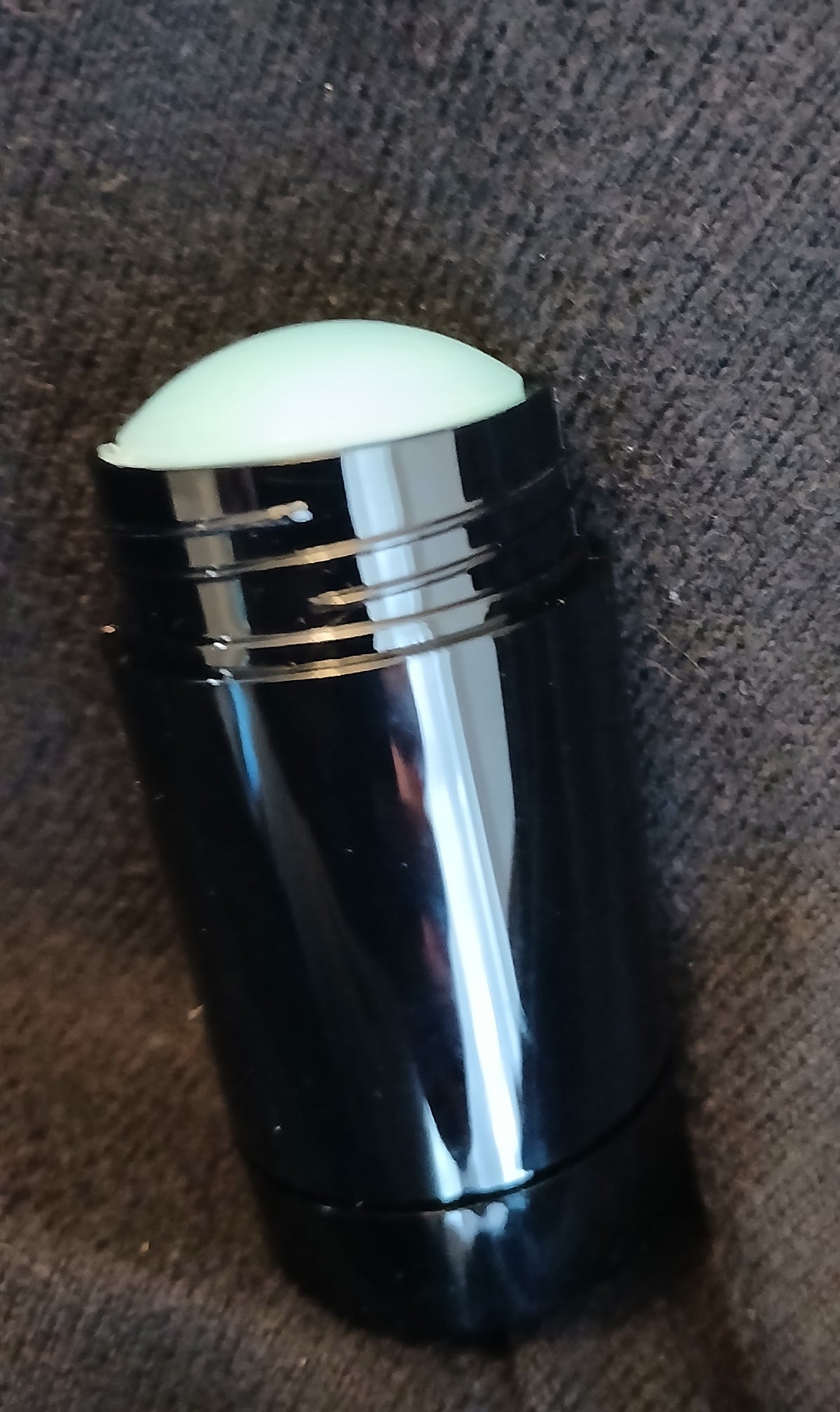 Intrigue Solid Cologne in a sleek black twist-up stick with Blue Amber and Bergamot fragrance