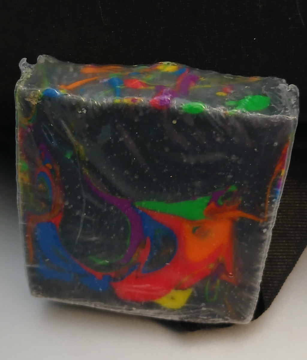 Neon Nights soap bar with vibrant neon swirls on a dark charcoal base