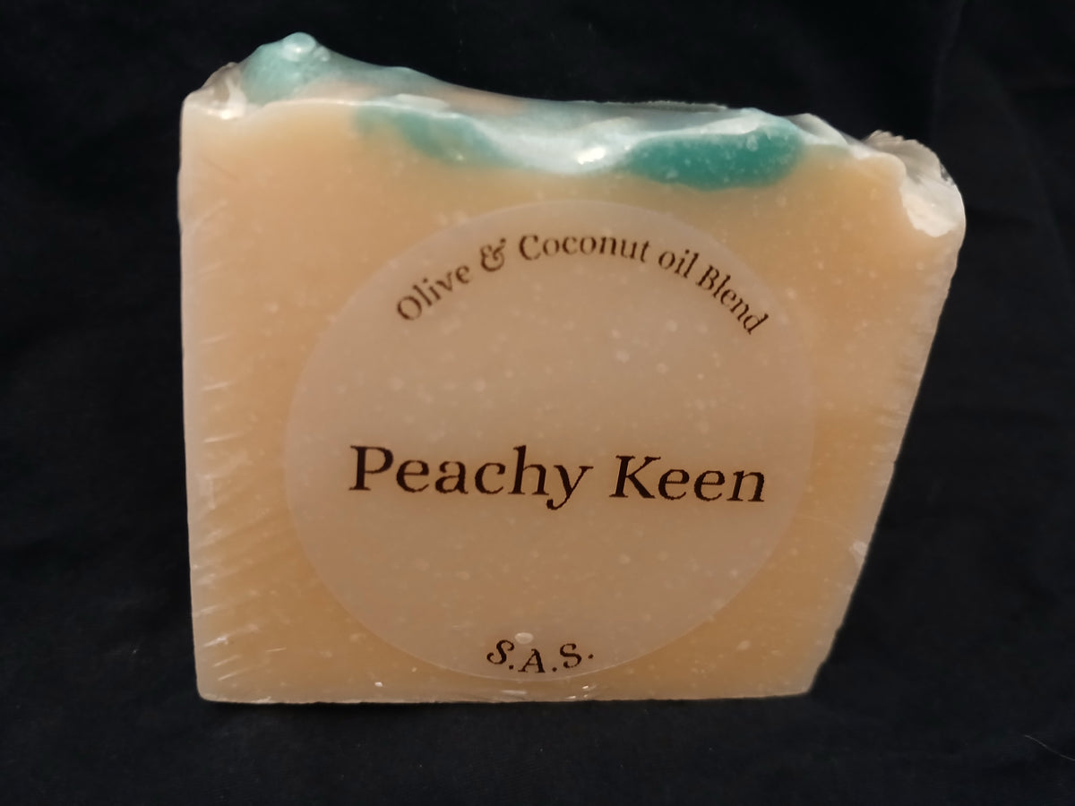 Peachy Keen olive and coconut oil soap bar with peachy tones and teal swirl on top, S.A.S. label