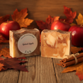 Spiced Apple soap bar in a cozy autumn setting with leaves, cinnamon sticks, and apples