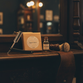 Barber Shop kraft paper wrapped soap bar in a vintage barbershop setting with straight razor and shaving brush